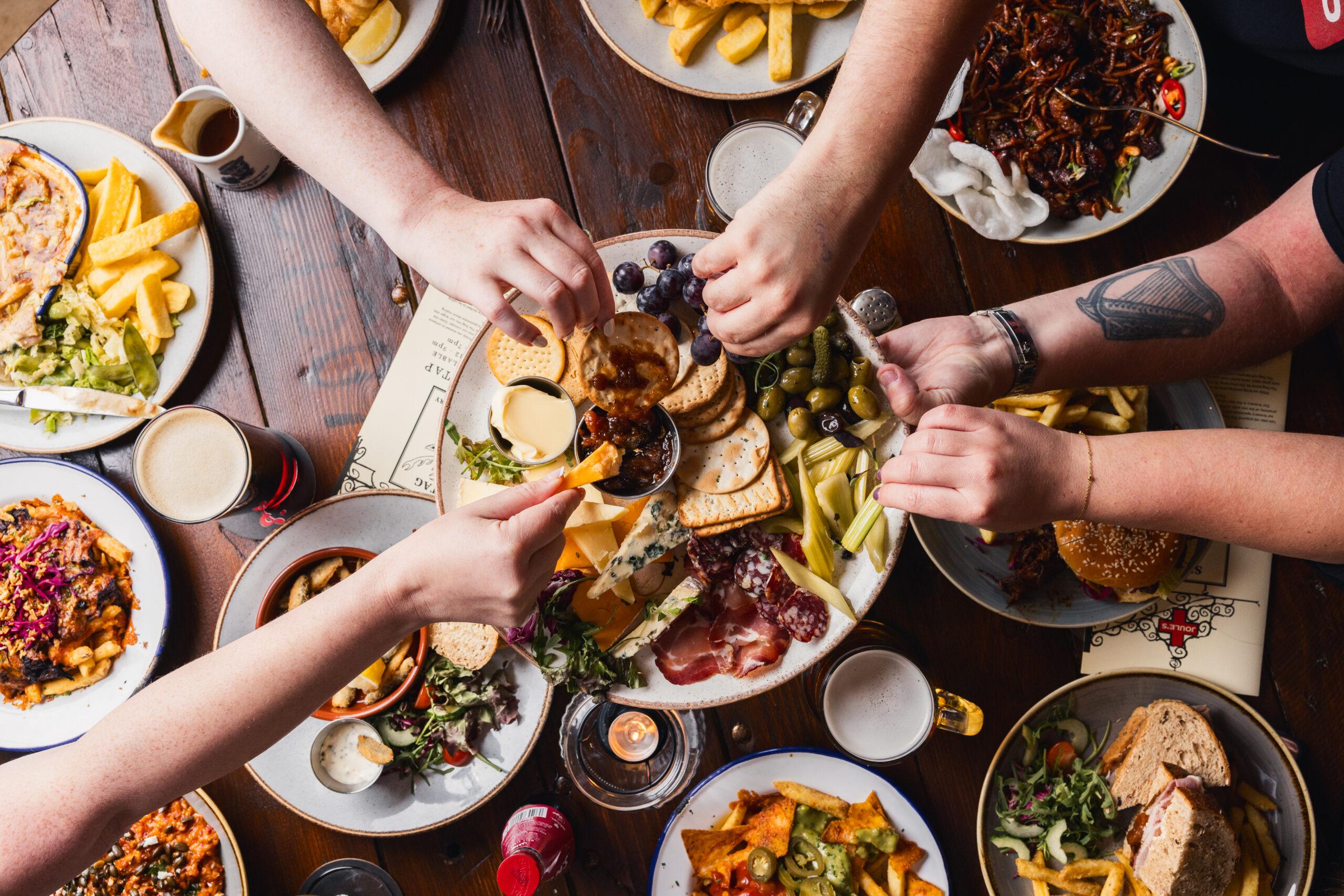 Friends dig in to some food at a Joule's Taphouse